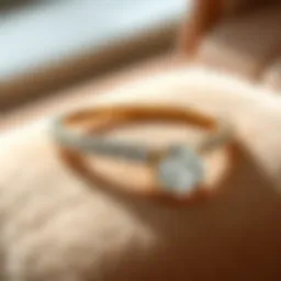 Elegant round diamond thin gold band resting on a plush surface