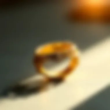 A close-up view of a gold ring with intricate detailing reflecting light.