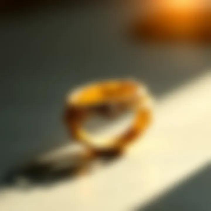 A close-up view of a gold ring with intricate detailing reflecting light.